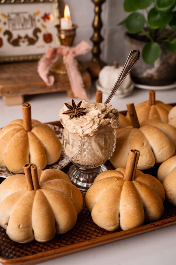 Chai pumpkin rolls that are shaped like a pumpkin with a cinnamon stick for a stem.